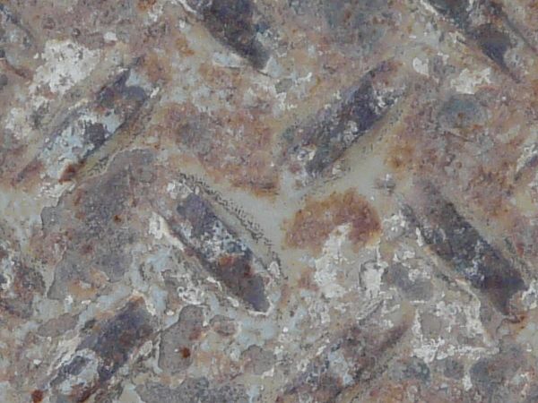 Old metal tread texture with repeating pattern and very worn surface.